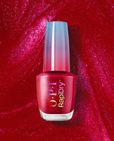 OPI Ring the Alarm RapiDry red shimmer nail polish bottle stands against a sparkling crimson polish background, showcasing a quick-dry shade for bold fall nail colors.