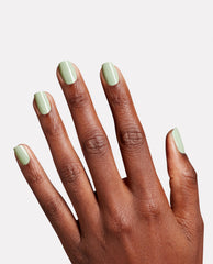 Hand displays glossy pale sage green nails polished with OPI Sage It for Later Nature Strong Vegan Nail Lacquer against a clean white background.