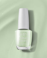 OPI Sage It for Later Nature Strong Vegan Nail Lacquer bottle in soft sage green with a white cap, standing on a glossy pale green background.