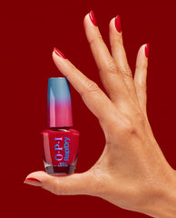 Hand with glossy red nails holds OPI RapiDry nail polish in Secs Appeal, a rich red fall nail color, against a deep red background with a blue-to-pink ombré cap.