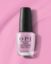 Seven Wonders of OPI nail lacquer bottle filled with soft pastel pink OPI nail polish, standing upright with a black textured cap on a matching pink background, showcasing the classic OPI branding for a salon-quality manicure look.