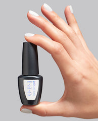 Hand with glossy white Snow AnGEL nails holding a black OPI GELElement at-home gel nail polish bottle against a light gray background, showcasing a sleek OPI nail polish gift set for salon-quality manicures at home.