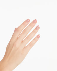 Hand showing neatly manicured nails painted with Somewhere Over the Rainbow Mountains OPI nail polish, a glossy muted rosy nude nail lacquer, against a clean white background for a modern minimalist beauty look.