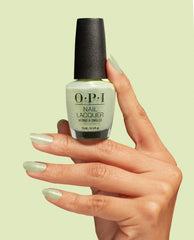 OPI AppointMINT Confirmed nail lacquer bottle held by a manicured hand with matching shimmery mint nails against a pale green background, showcasing green nail polish perfect for spring nail colors from OPI, 15 mL/0.5 fl oz.