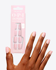 Hand with glossy pale pink manicure holds OPI Baby, Take a Vow On Point instant press-on mani, showing soft pink square nails in the OPI nail polish gift set packaging against a clean white background.