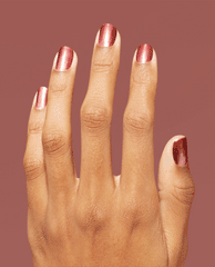 Hand with neatly manicured nails showcases OPI nail polish in Stellar Tips Infinite Shine, a shimmery rose-gold metallic shade, against a matching warm mauve background, highlighting the glossy, long-wear finish for US salon-quality nail looks.
