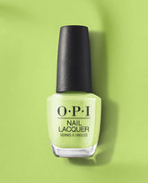 OPI Summer Monday-Fridays Nail Lacquer bottle showcasing bright green nail polish, standing upright on a matching green backdrop, a fresh pick for spring nail colors from OPI with a glossy, creamy finish.