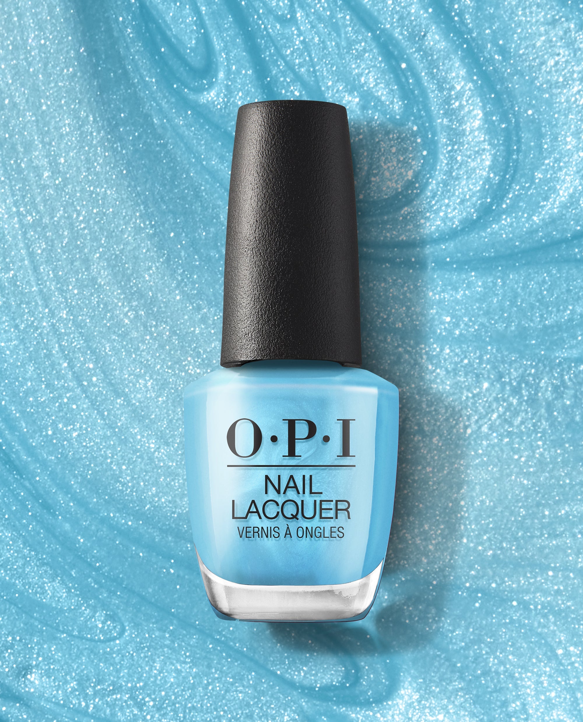 OPI Surf Naked nail lacquer bottle standing upright on shimmering light-blue polish smear background, featuring a sky-blue shade from trending nail colors.
