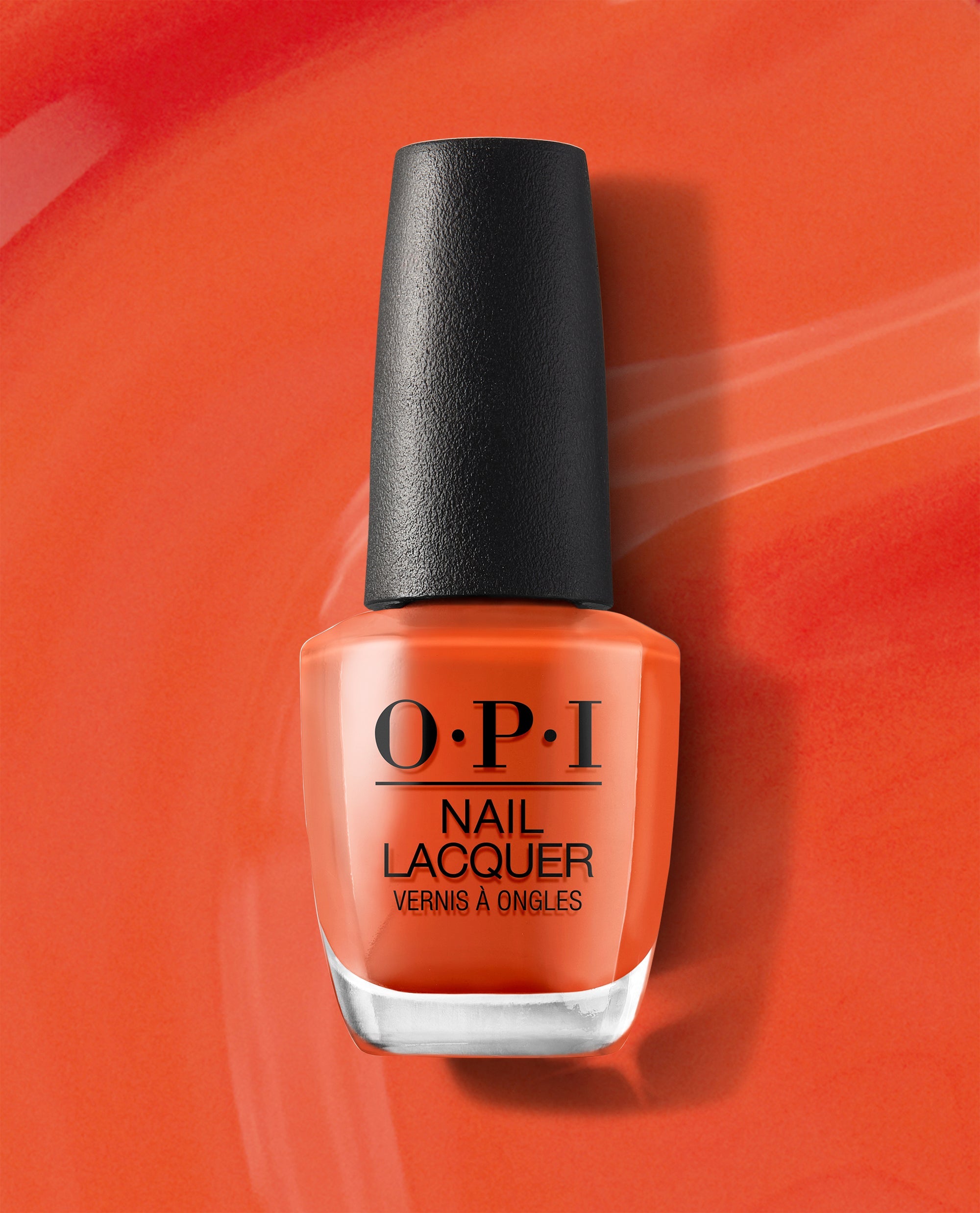 OPI nail polish bottle, Suzi Needs a Loch-smith nail lacquer, stands upright showing its bright burnt orange shade against a matching glossy orange painted background, highlighting the bold, creamy color for manicures and pedicures.