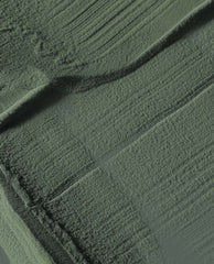 Suzi - The First Lady of Nails dipping powder swatch spreading in velvety, brush-textured strokes across a flat surface, showcasing an olive green nail polish shade for spring nail colors by OPI.
