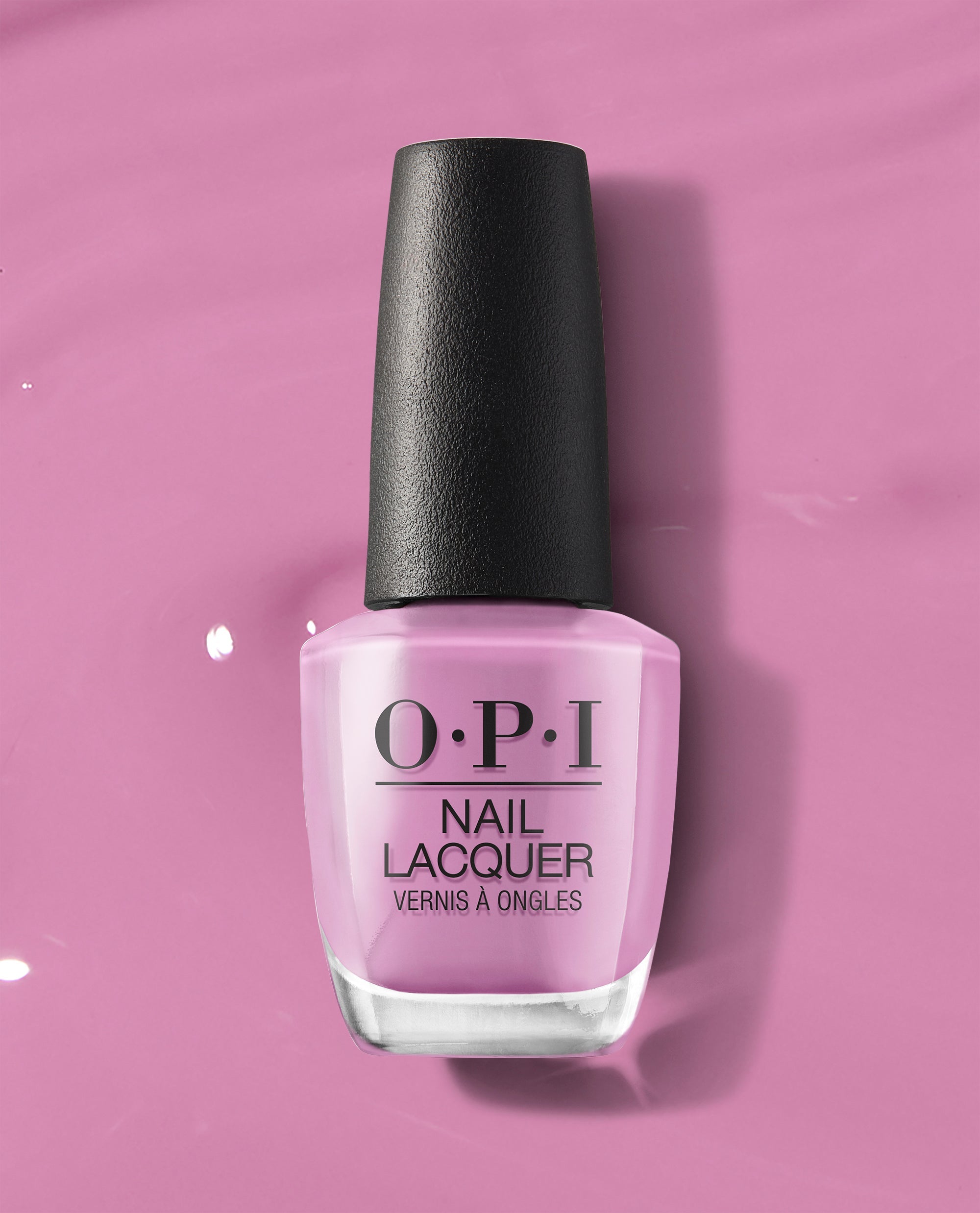 OPI nail polish bottle in Suzi Will Quechua Later! soft mauve-pink shade standing upright with a black cap against a matching glossy pink lacquer background, showcasing the nail lacquer color and branding.