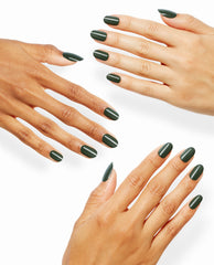 Hands showcase glossy dark forest green OPI Suzi - The First Lady of Nails polish on rounded On Point manicures against a clean white background.
