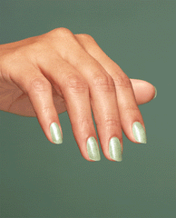 Hand with long almond-shaped nails shows off Taurus-t Me OPI nail polish, a shimmery light sage green nail lacquer, against a matching green background for a cohesive manicure beauty look.