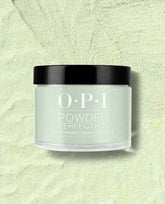 OPI Powder Perfection Taurus-t Me dipping powder jar displaying a pale mint green shimmer for green nail polish and spring nail colors, set on a matching speckled powder background with OPI logo and black lid in view.