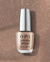 OPI Infinite Shine Track Suited Cutie gel-like lacquer bottle in a warm taupe shade with gold shimmer, displayed on a matching glitter background for fall nail colors.