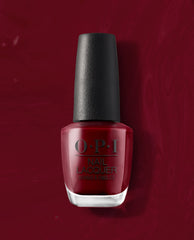 OPI We the Female nail lacquer bottle stands upright, showing a deep red polish shade against a matching glossy red background, ideal for rich fall nail colors.