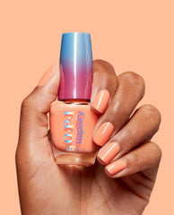 OPI RapiDry Within Peach nail polish bottle held by a hand with glossy peach manicure, featuring a blue-to-magenta cap against a matching peach background for a trending summer nail look.