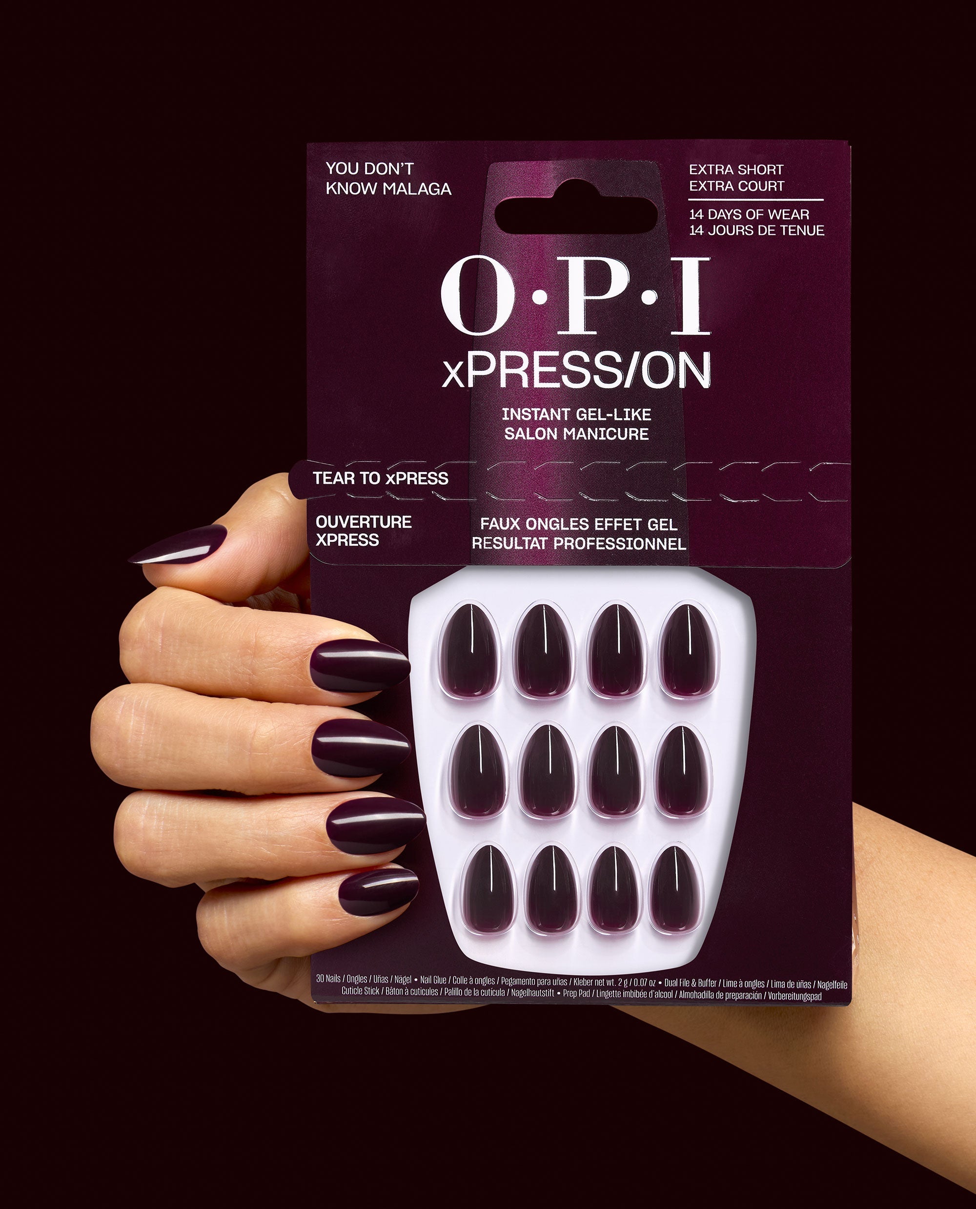 OPI xPRESS/ON You Don’t Know Malaga press-on nails in deep burgundy are shown on a manicured hand holding the matching package, highlighting glossy extra-short fall nail colors.