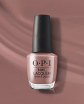 OPI You Don’t Know Suzi nail lacquer bottle stands upright, showing a soft dusty mauve-taupe polish with a black textured cap against a matching satin backdrop.