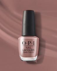 OPI You Don’t Know Suzi nail lacquer bottle stands upright, showing a soft dusty mauve-taupe polish with a black textured cap against a matching satin backdrop.