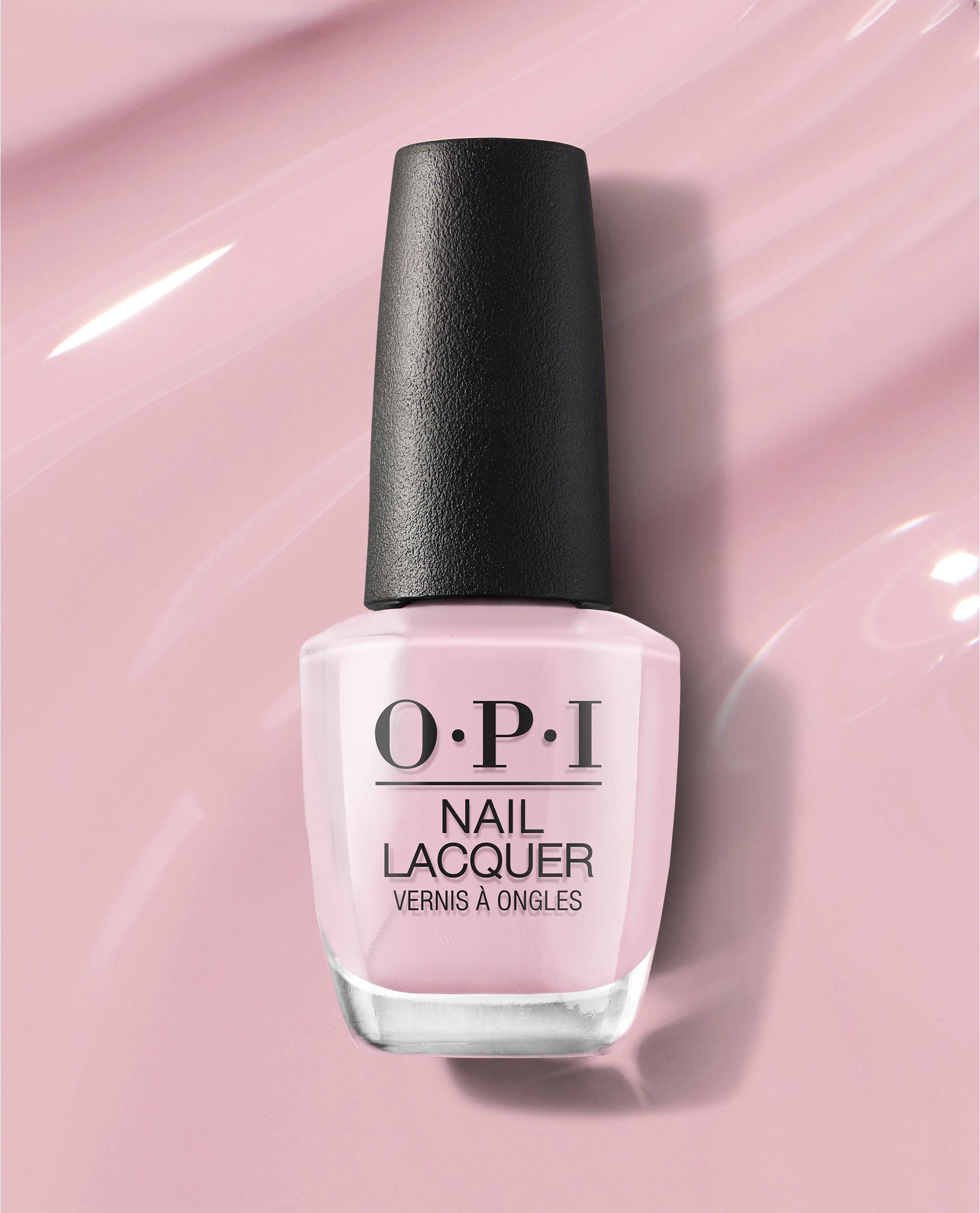 OPI nail polish bottle of You’ve Got that Glas-glow nail lacquer standing upright, showcasing its soft pastel pink shade with a black cap against a glossy light pink background, highlighting a smooth, glass-like finish.