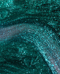 Yuletide Sweetings! nail lacquer swatch—emerald green nail polish swirling with fine glitter, shimmering under light in a glossy macro close-up; a festive pick for spring nail colors that complements OPI collections.