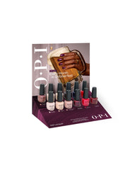OPI Fall '26 Nail Lacquer 12PC Vac Tray Display showcases 12 fall nail colors on a burgundy retail tray, backed by Every Month is Oktoberfest artwork of a hand with purple nails holding a beer stein.