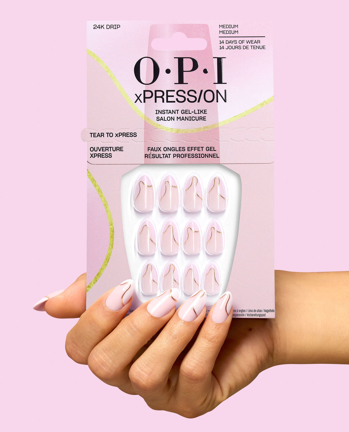 OPI 24K Drip xPRESS/ON medium press-on nails in pale pink with gold swirl accents, held in matching packaging against a pink background for chic fall nail colors.