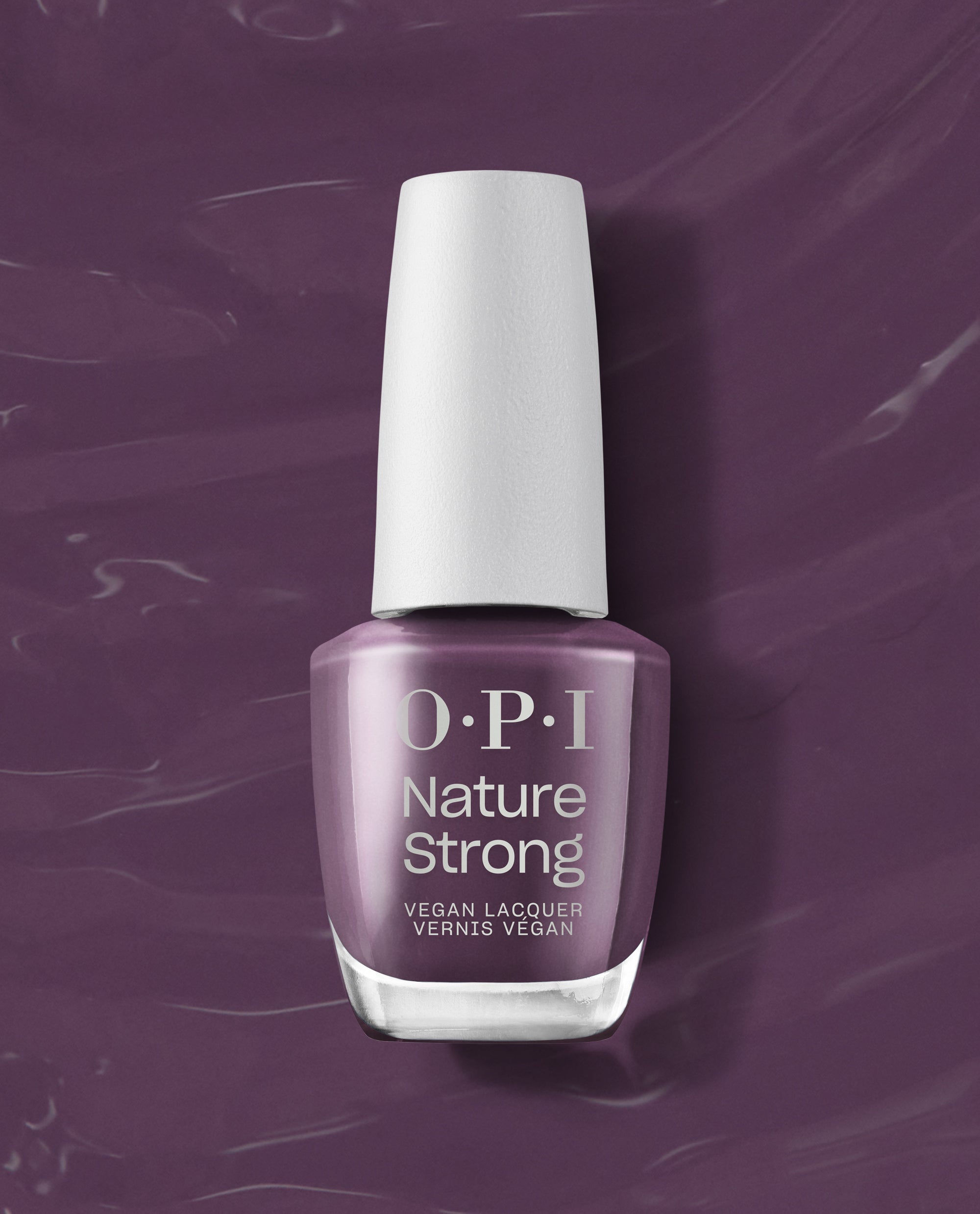 OPI Nature Strong Vegan Nail Lacquer in Eco-Maniac, a muted plum-purple fall nail color, stands upright with a white cap against a glossy purple polish-swipe background.