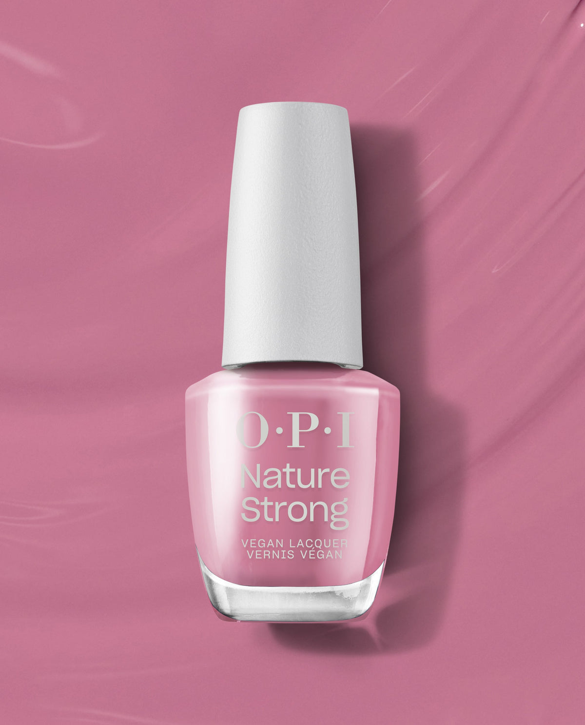 OPI Nature Strong Vegan Nail Lacquer in Knowledge is Flower, a soft rosy pink polish in a glass bottle with white cap, standing upright on a matching pink background, ideal as a clean beauty OPI nail polish gift set.