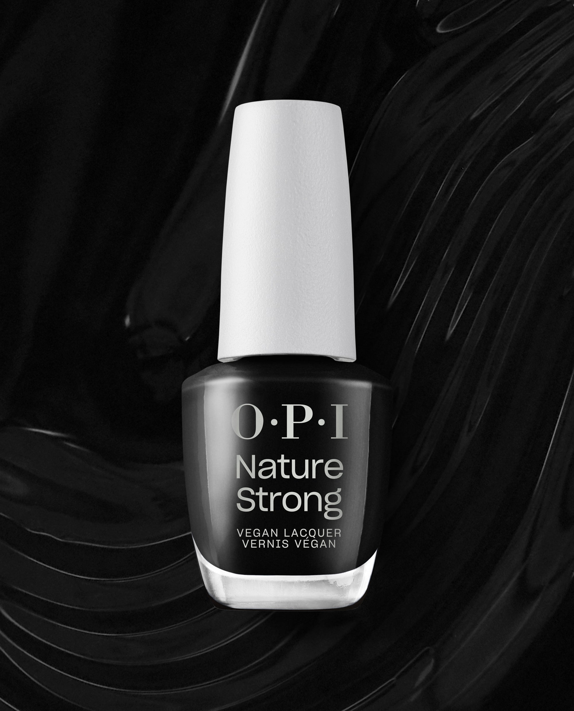 Onyx Skies OPI Nature Strong Vegan Nail Lacquer bottle stands against a glossy black brushstroke background, showcasing a trending deep black nail polish shade with a white cap.