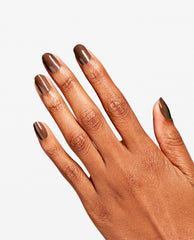 Hand displays a glossy Awe of a Sudden RapiDry manicure, a warm shimmery brown OPI fall nail color, on short rounded nails against a clean white background.