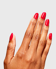Hand displays a glossy hot pink OPI RapiDry manicure in Haul Sass, with almond-shaped nails against a light gray background, showcasing bold fall nail colors.