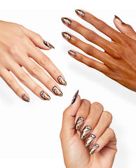 Hands display OPI Make My Art Flutter Sticking Point nail art for fall nail colors, with almond nails in nude, gold, peach, and black butterfly-wing designs on a clean white studio background.