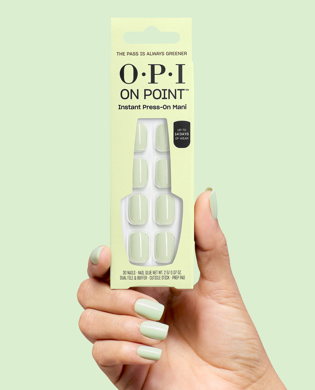 OPI On Point The Pass is Always Greener press-on nails in pale mint green, held in a hand with matching glossy manicure against a soft green background.