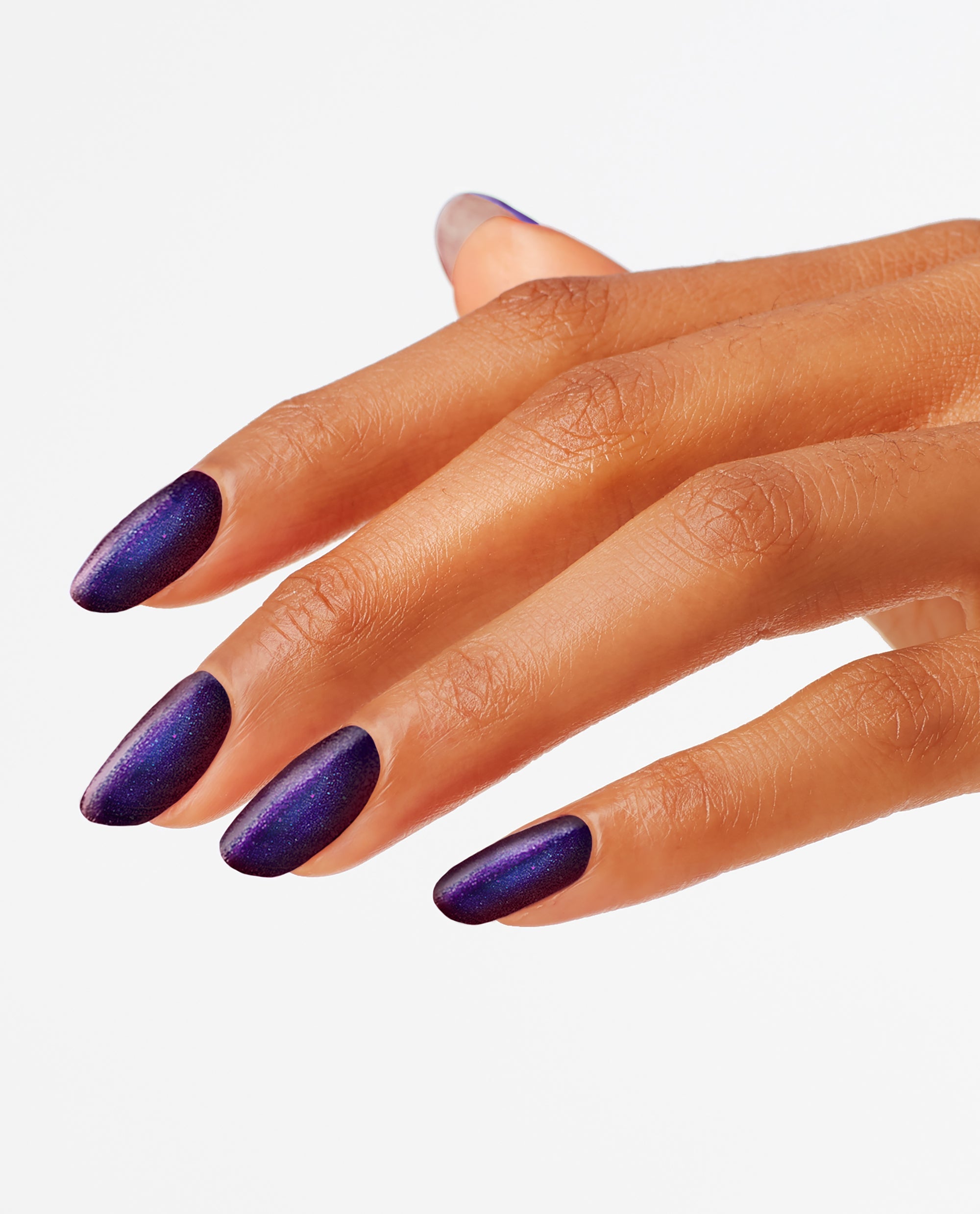 Hand with almond-shaped nails painted in Abstract After Dark, a deep shimmery midnight purple OPI nail polish nail lacquer, angled against a clean white background to showcase the bold, glossy manicure color for evening looks.