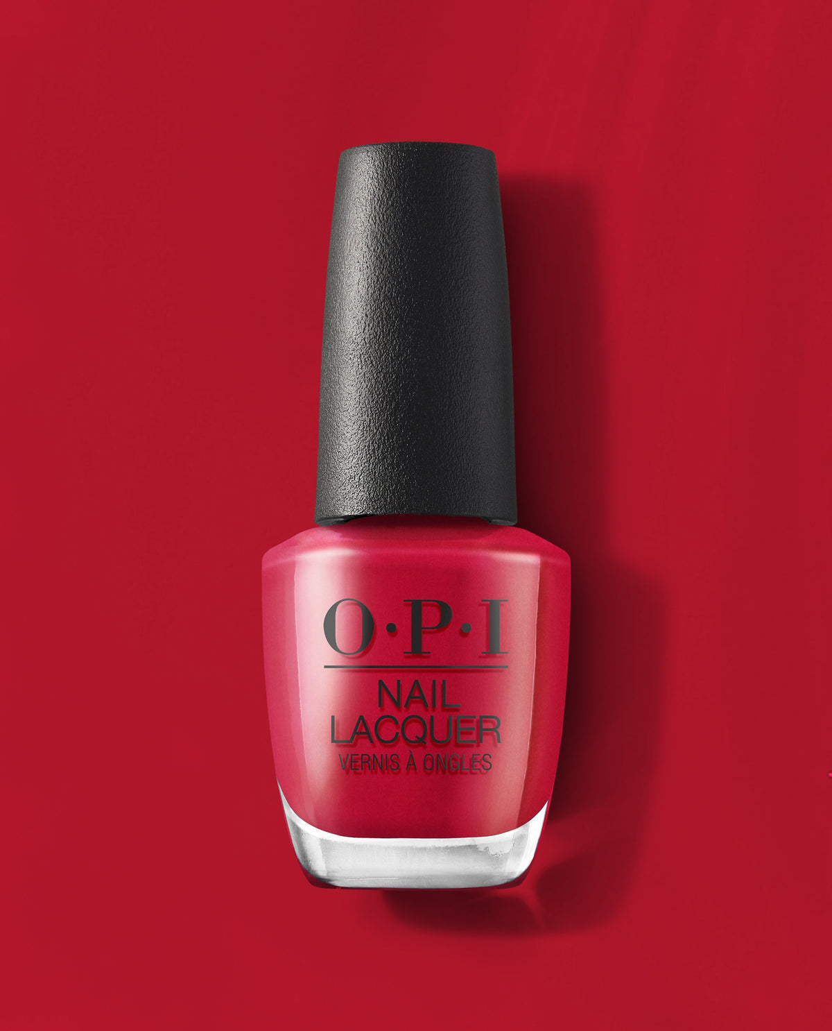 OPI nail polish bottle in the shade Art Walk in Suzi's Shoes, a vibrant classic red nail lacquer with a black textured cap, standing upright against a matching glossy red background for a bold manicure look.