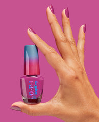 Hand with glossy magenta nails holding an ASAPink OPI RapiDry nail polish bottle against a matching pink background, showcasing the gradient blue-to-pink cap and stylish manicure, ideal for an OPI nail polish gift set product page.