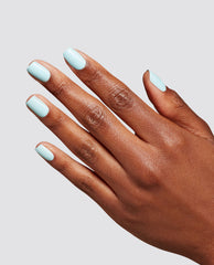 Hand displays a glossy Baby Blue Me Away manicure with soft pastel blue OPI RapiDry nail polish on short rounded nails against a light gray studio background.