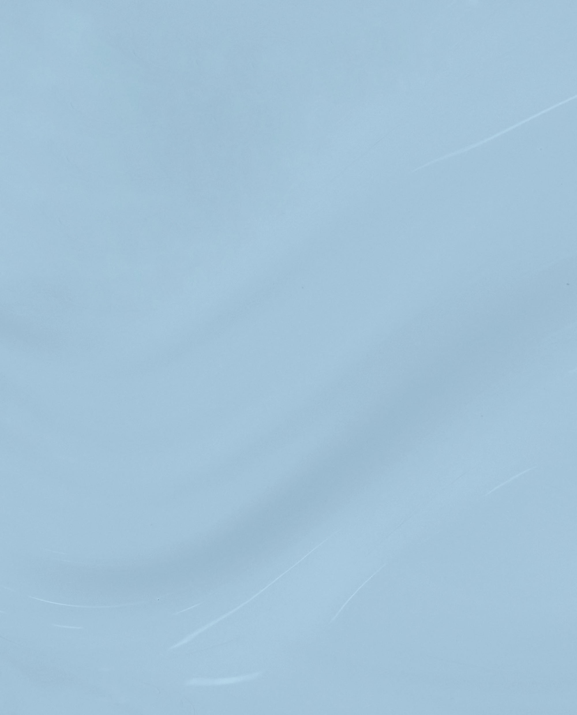 Soft denim-blue Baggy Jean Baby nail lacquer swatch gliding in glossy waves on a clean background, showcasing a creamy, opaque finish perfect for fall nail colors.