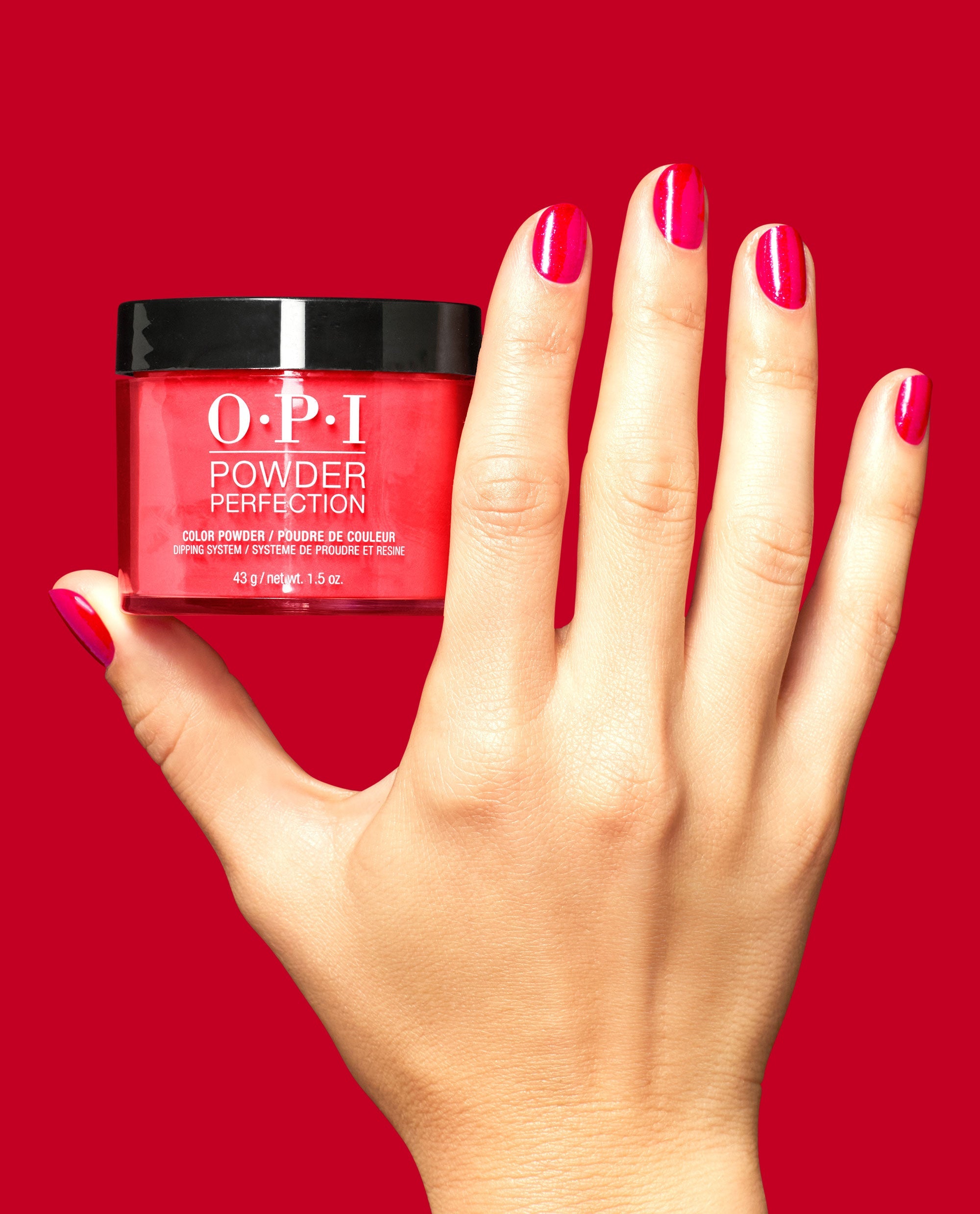 Big Apple Energy Shimmery Red Nail Dip Powder Hand and Product