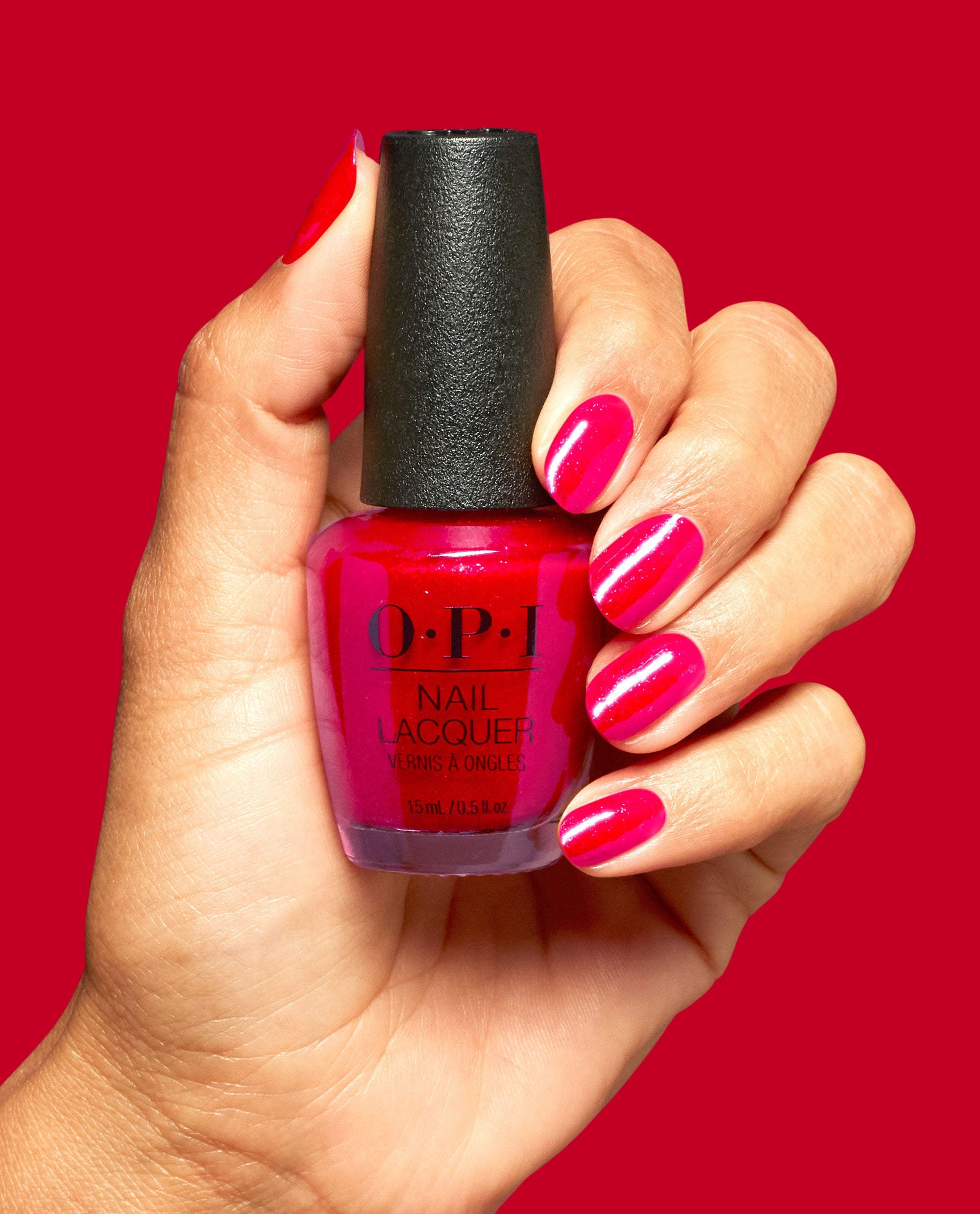 Big Apple Energy Shimmery Red Nail Polish Hand and Product