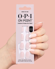Hand holding OPI On Point Bride or Die instant press-on mani with pale pink almond French tip nails, up to 14 days of wear, against a soft pink background; a chic option among fall nail colors.
