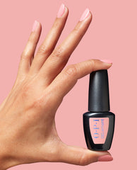 Hand with glossy pastel pink BubbleYUM at-home gel nail polish manicure holding an OPI GEL element bottle against a matching pink background, highlighting the OPI nail polish gift set color and salon-quality finish for at-home use.