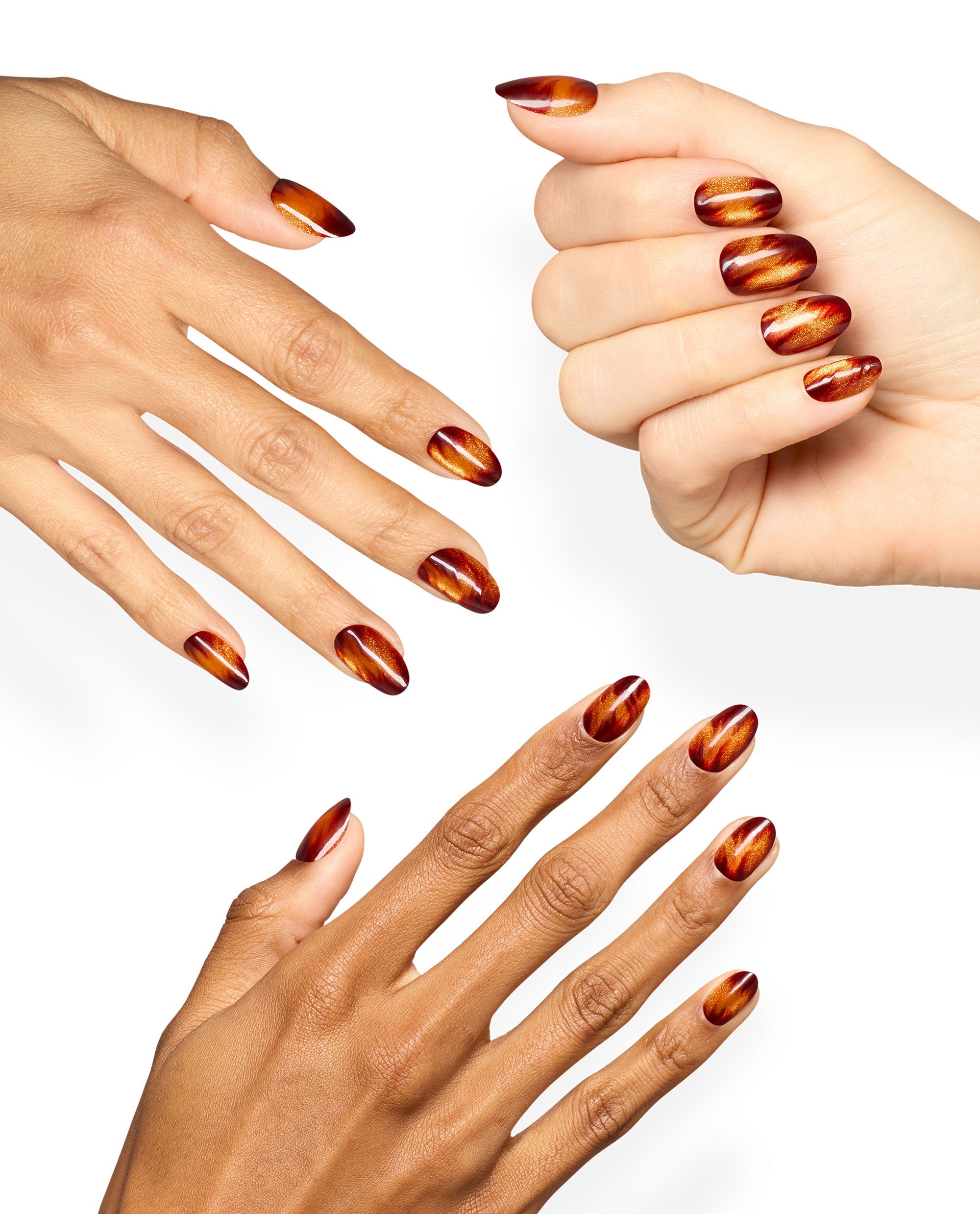 Hands show OPI Burn After Glazing xPRESS/ON nails in glossy burgundy and metallic copper swirls, a dramatic set of fall nail colors on a clean white background.