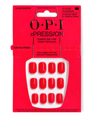 OPI xPRESS/ON Cajun Shrimp press-on nails in glossy coral-red, displayed in bright red retail packaging for an instant gel-like salon manicure with classic 14-day wear.