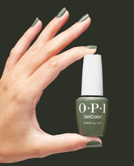 OPI GelColor Cargo All Out gel nail polish bottle held between fingers, with nails painted the same muted olive green; chic green nail polish choice for spring nail colors, perfect for US manicures, set against a dark background.