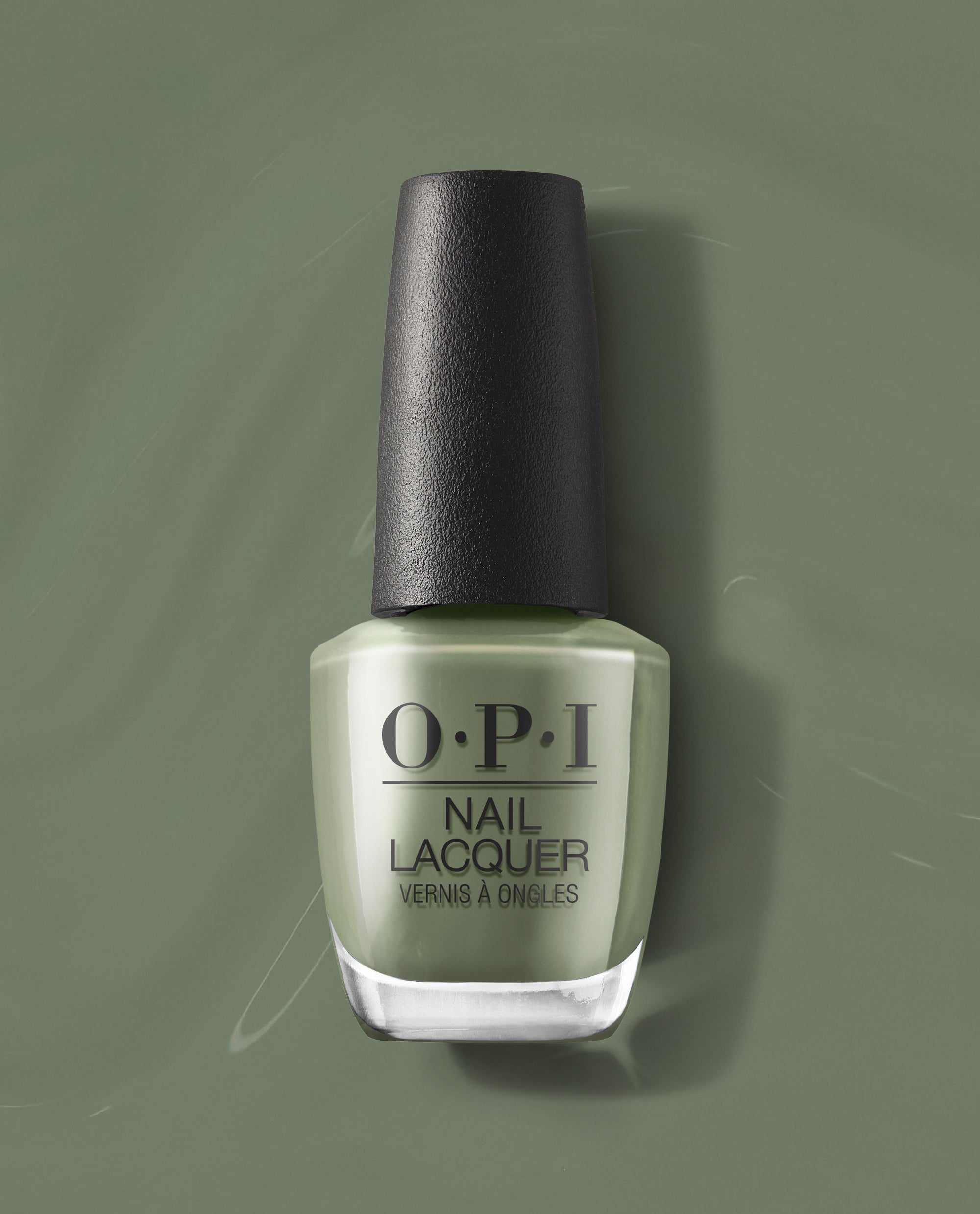 OPI Nail Lacquer bottle in Cargo All Out stands upright, showing creamy sage green nail polish with a glossy finish and black textured cap on a tonal green backdrop, a fresh pick for spring nail colors by OPI.