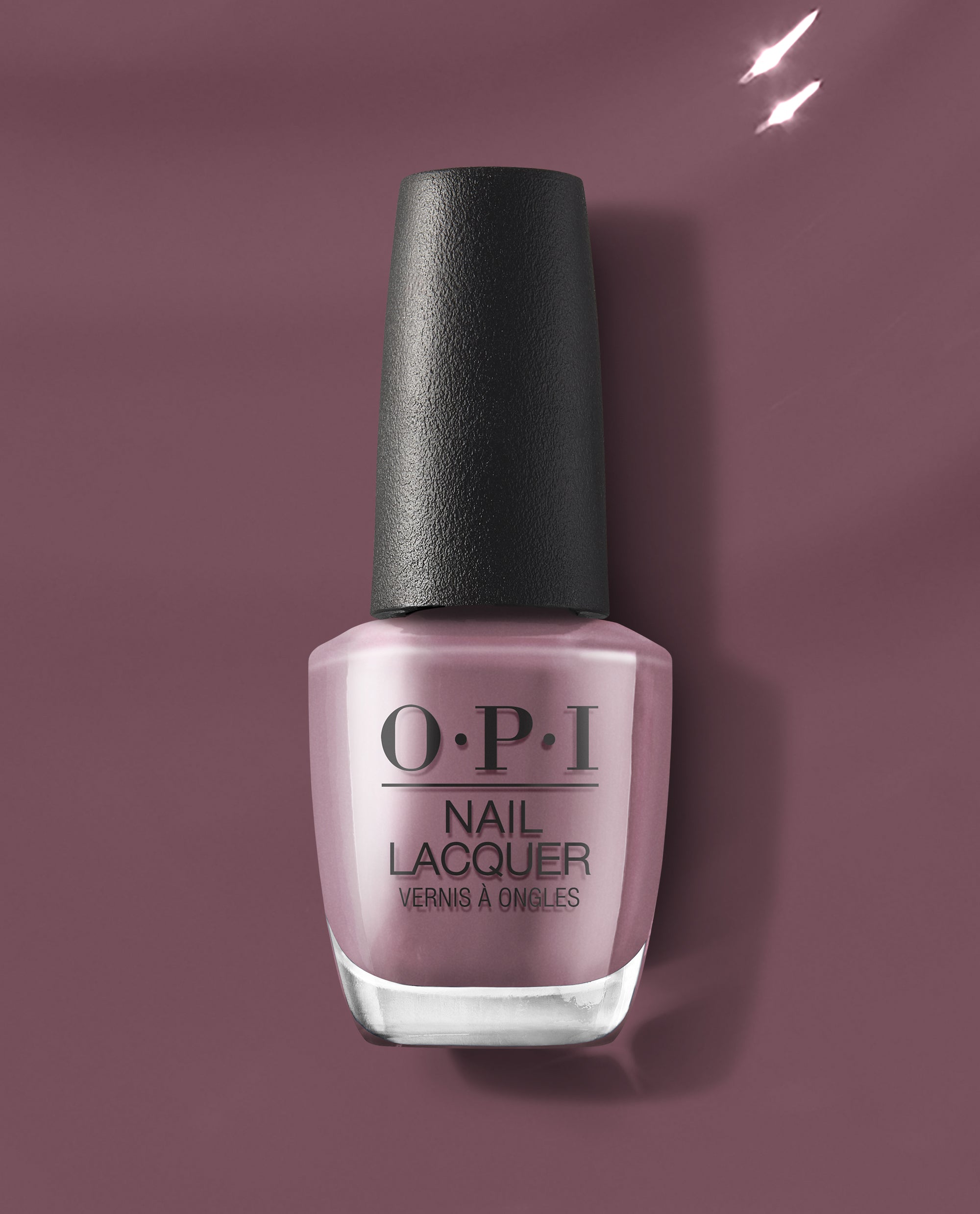 OPI nail polish Claydreaming nail lacquer bottle standing upright, showing its dusty mauve shade and black textured cap against a matching mauve background, highlighting the creamy, full-coverage formula for at-home manicures.