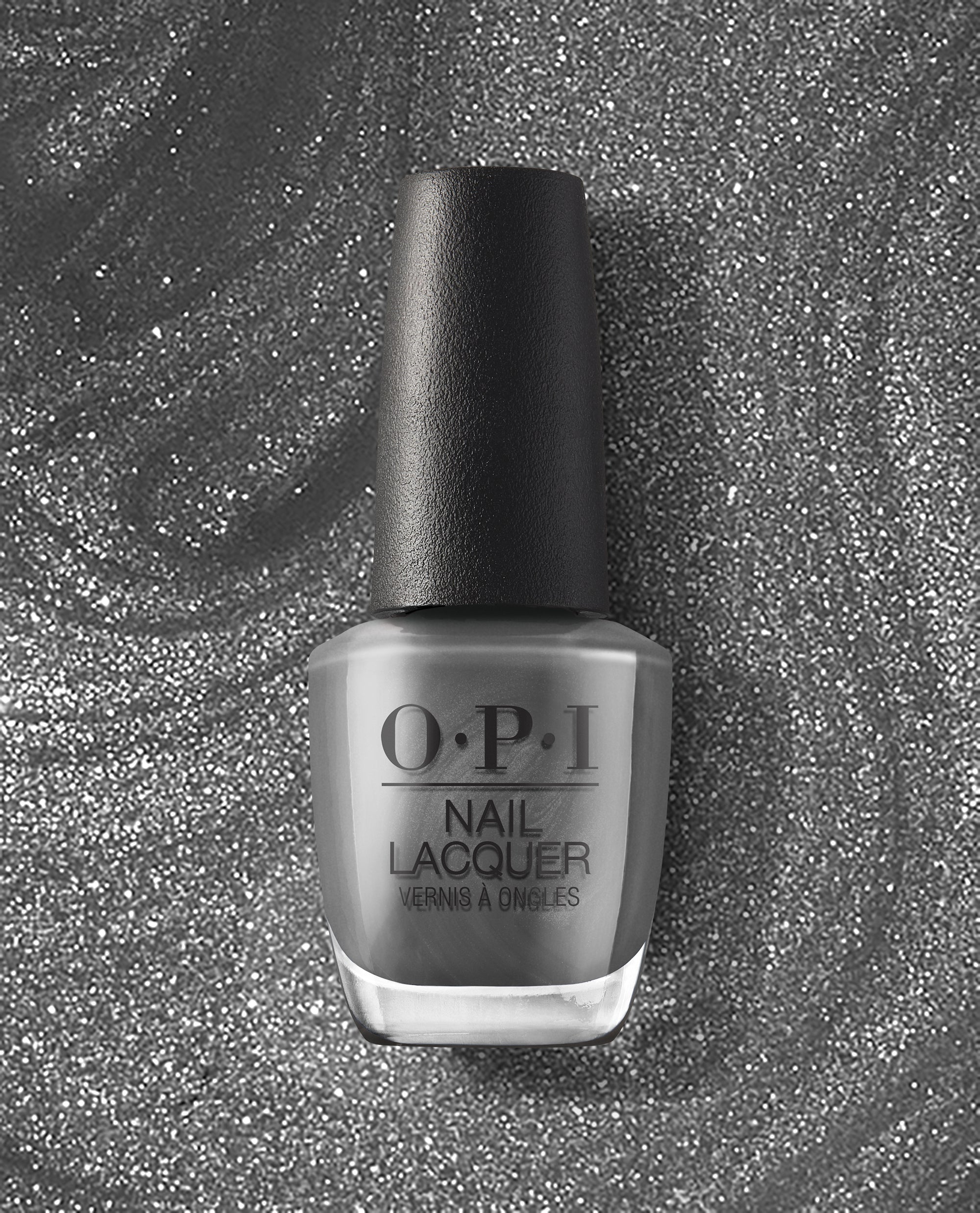 OPI nail polish bottle of Clean Slate nail lacquer standing upright, showcasing a sleek medium gray shade with a black cap against a swirling silver glitter background, highlighting the modern, neutral color for manicures and pedicures.